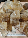Raw Citrine on digital scale with quarter to compare size.