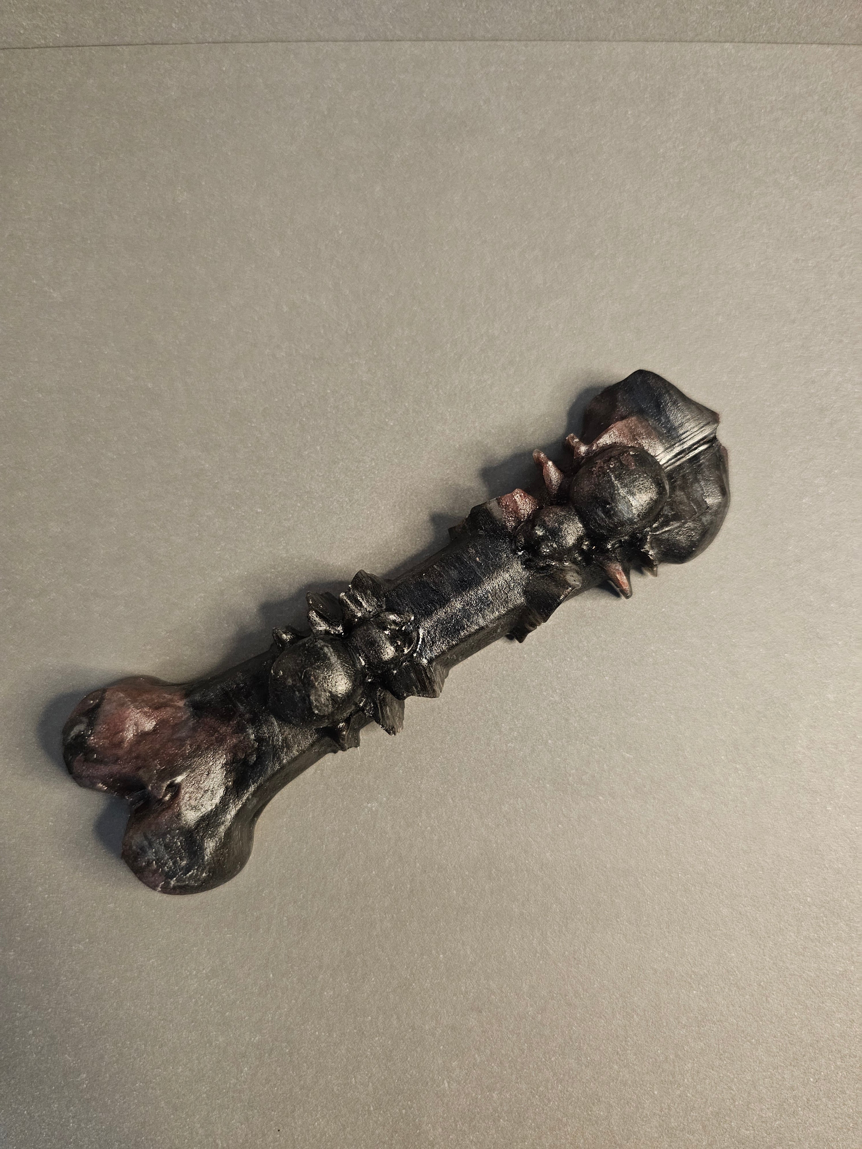 Garnet Astrophyllite bone carving with two spiders carved on it.