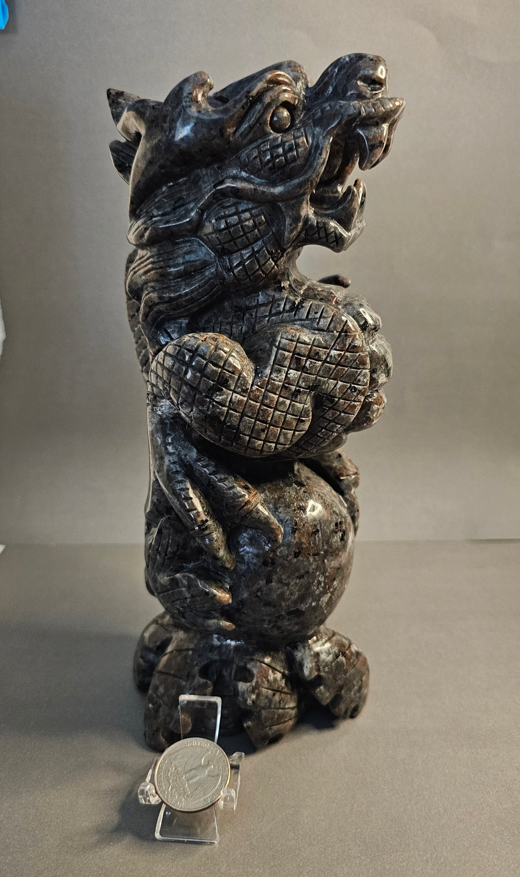 Right side of Emberlite dragon with ball shown next to quarter for size comparison.
