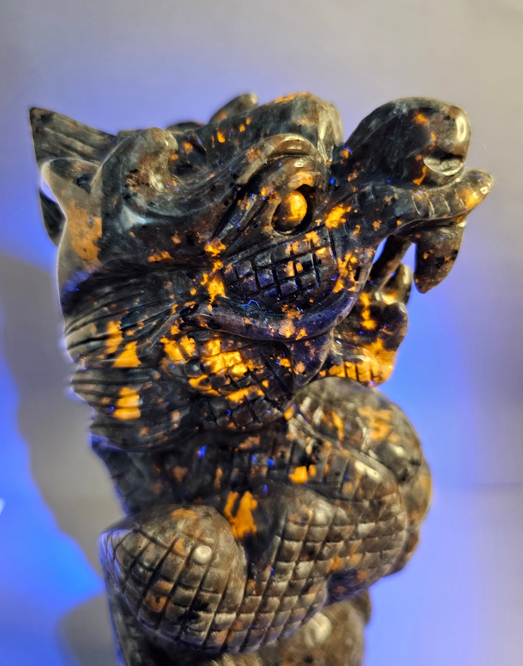 Close up of the right side of Emberlite dragon with ball glowing under UV light.