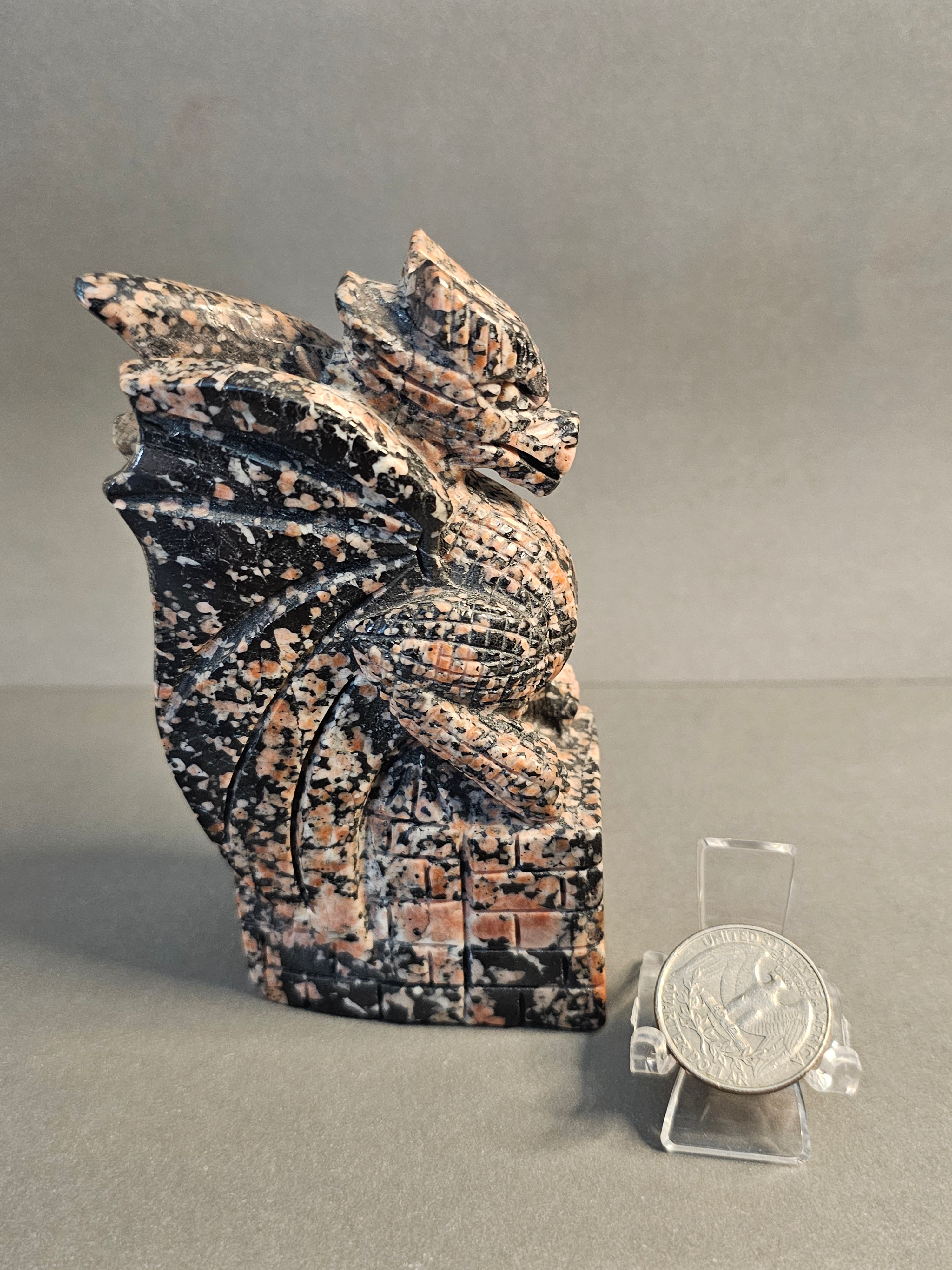left side of dragon on castle carved out of Willemite shown with quarter for size comparison